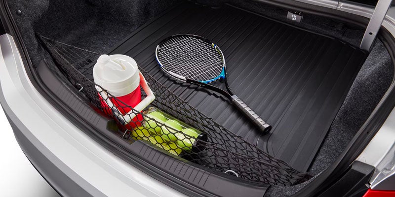 A tennis racket, tennis balls and water cooler in the trunk of a 2025 Chevy Malibu