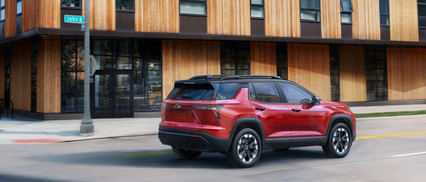 2027 Chevy Equinox Exterior Driving Past Building